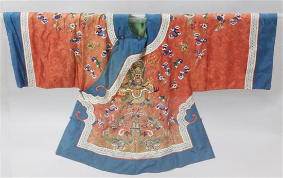 A Chinese terracotta silk damask womans dragon and phoenix  jacket, c.1920, length 73cm, removable perspex case